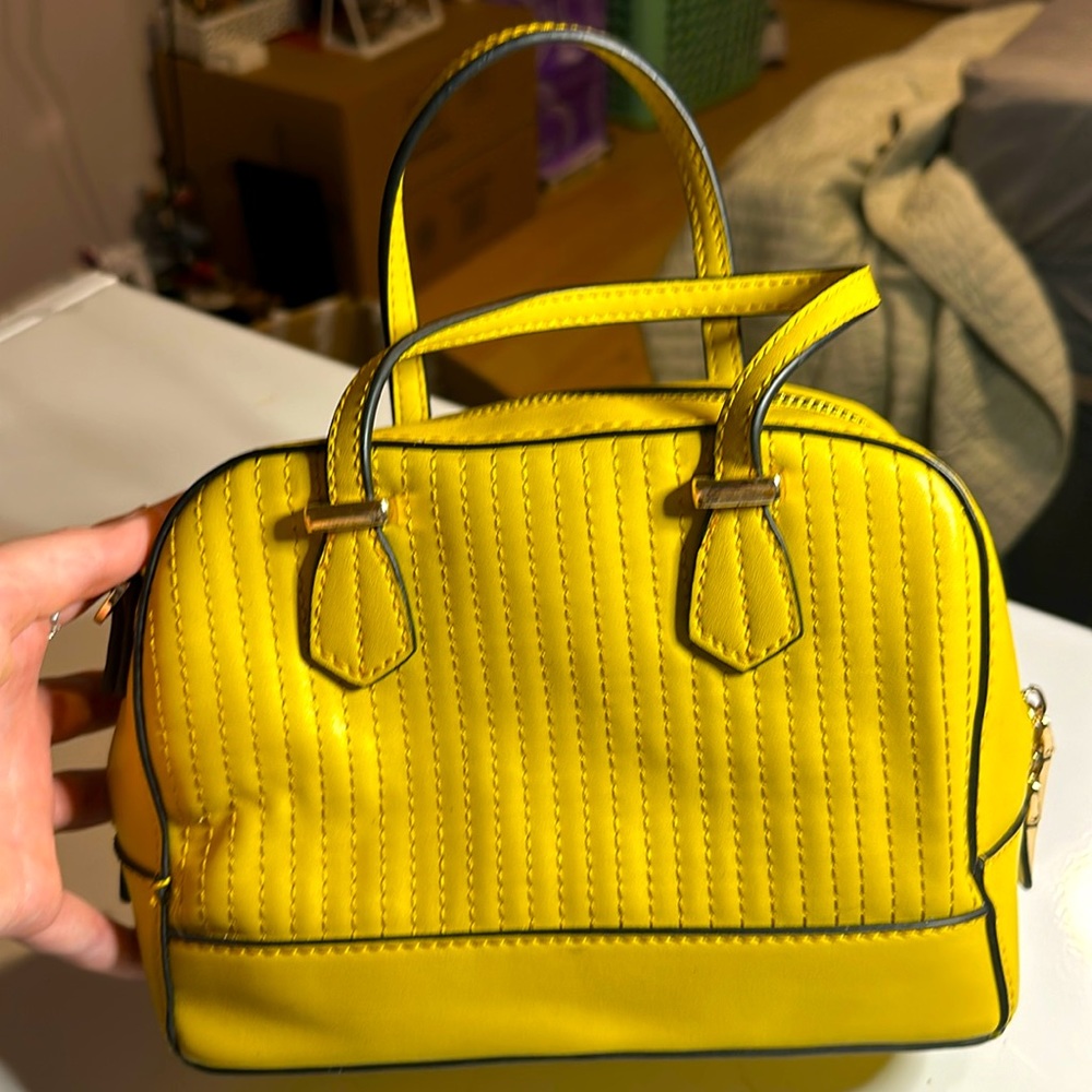 mild yellow colored mini purse from Urban Expressions. floral inside.